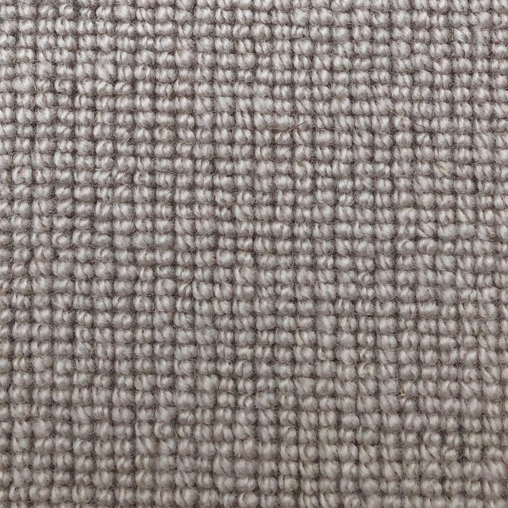 Close-up of beige woven fabric texture.