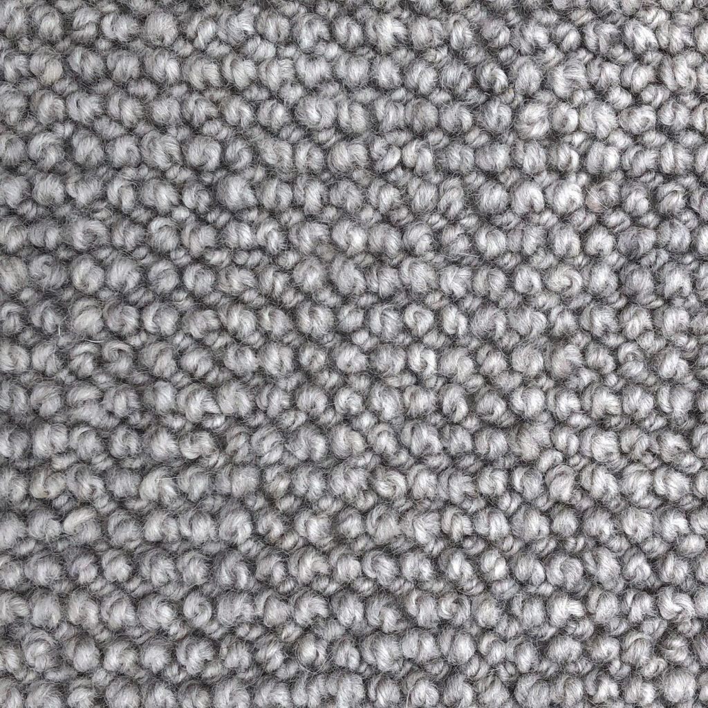 Gray loop pile carpet texture close-up.