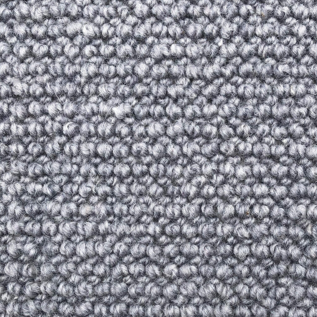 Gray textured carpet with looped pile design.