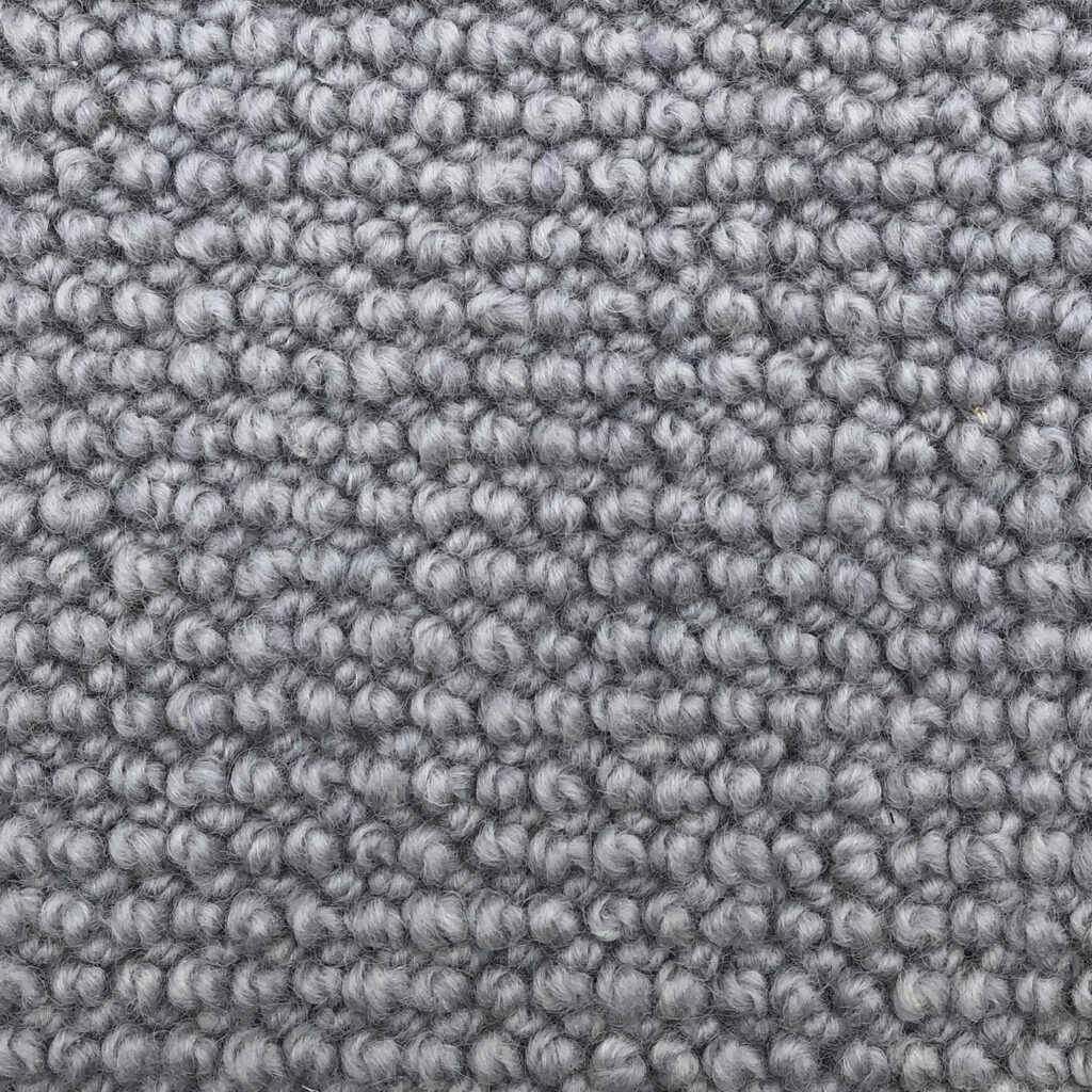 Gray textured carpet with looped fibers.