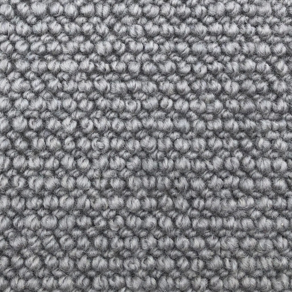 Close-up of grey textured carpet fabric.