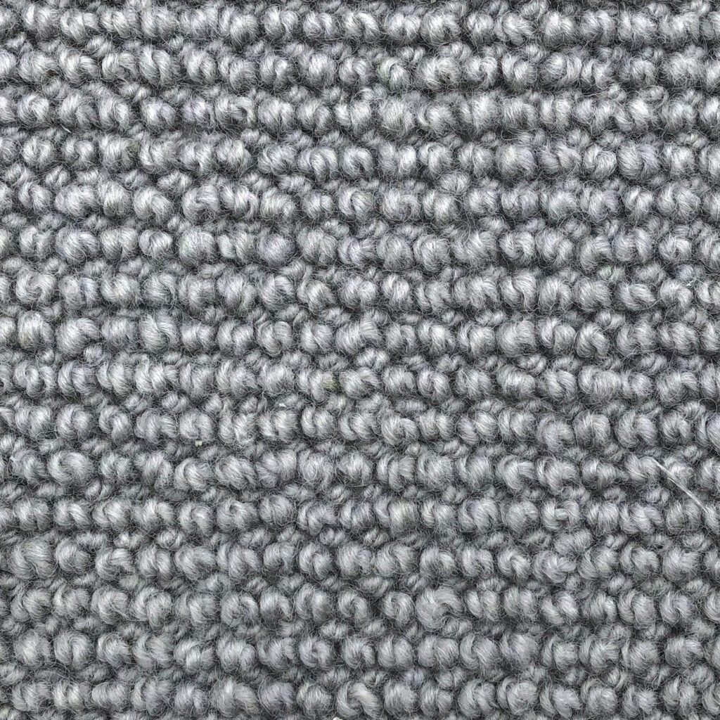 Close-up of textured gray carpet fibers.