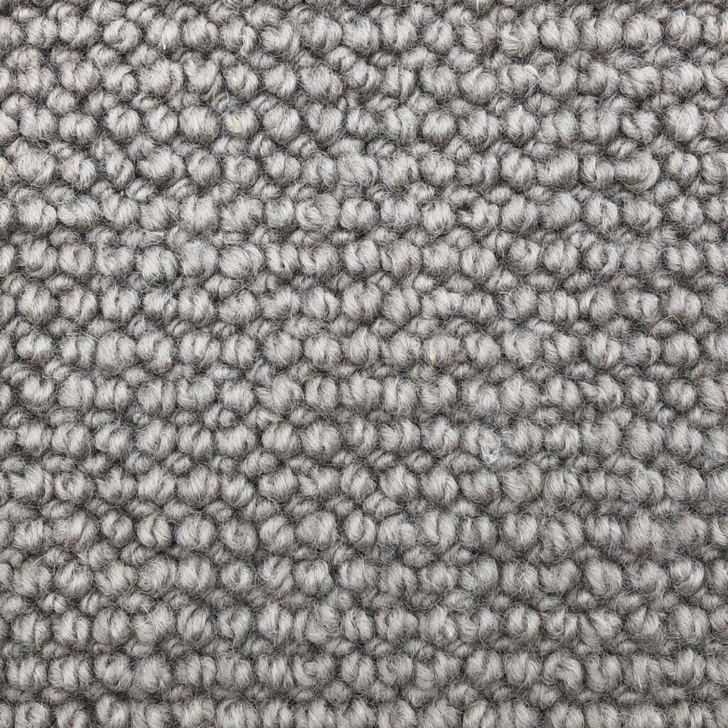 Close-up of textured gray carpet fibers.