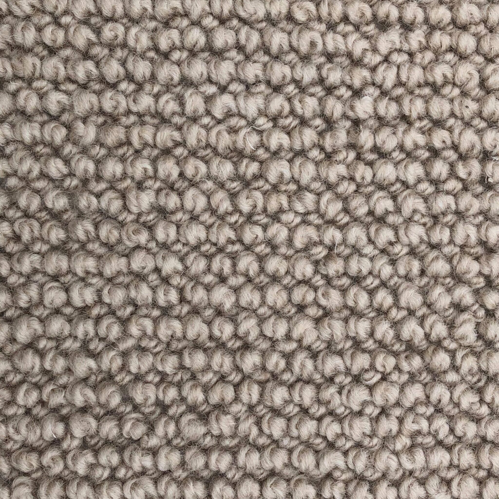 Close-up of textured beige carpet fibers.