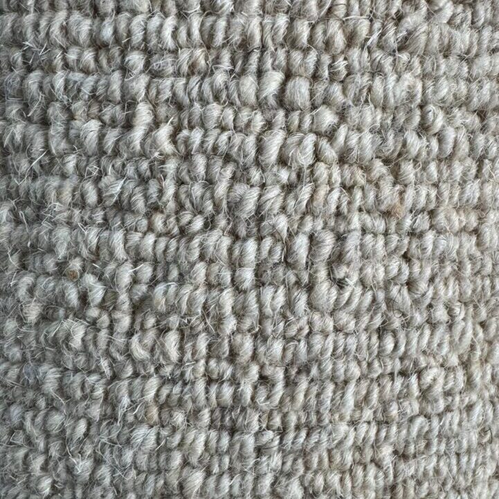 Close-up view of a Wool Loop Remnant with a looped texture in a light grey color.
