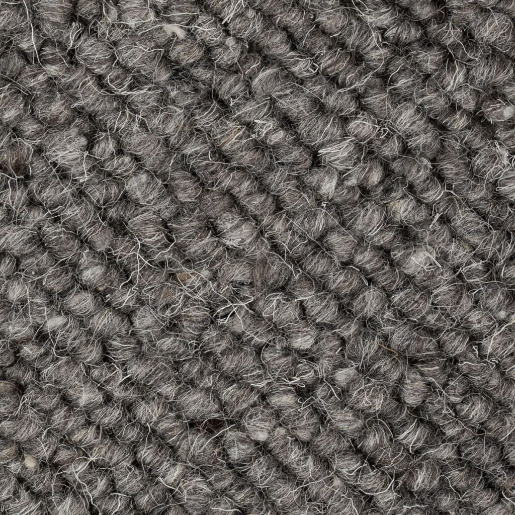 Gray textured wool carpet close-up.