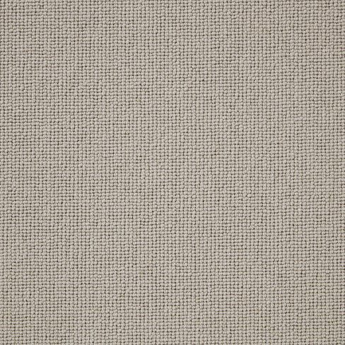 A close-up of beige fabric texture with a tightly woven pattern.