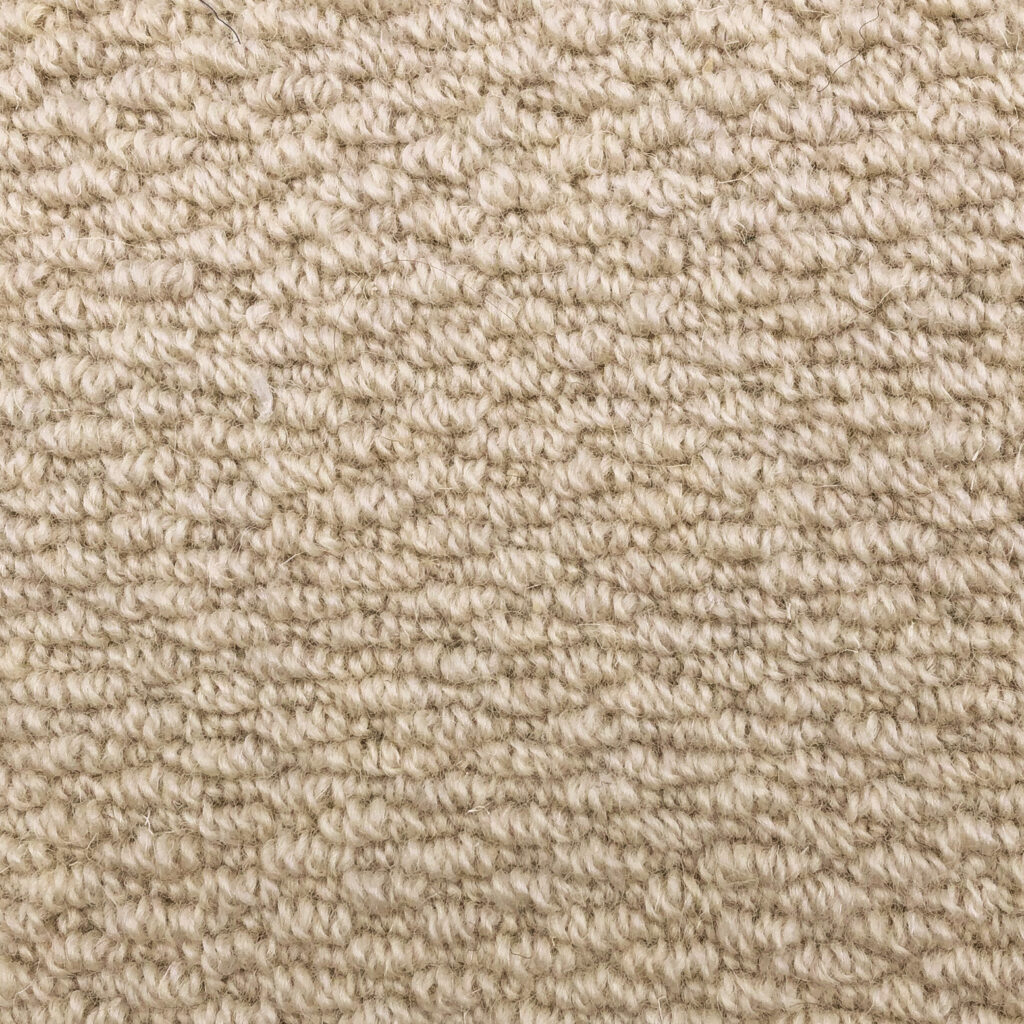 Beige textured carpet close-up view.