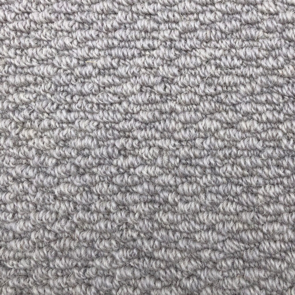 Gray textured carpet close-up pattern view.